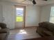 A living room featuring couches and tile floors with an entrance door at 888 Berkley Rd, Auburndale, FL 33823