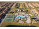 Aerial view of community amenities including a pool, clubhouse, tennis courts, and lush landscaping at 8949 Candy Palm Rd, Kissimmee, FL 34747