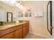 Bathroom featuring double vanity with granite countertop and decorative wall art at 8949 Candy Palm Rd, Kissimmee, FL 34747