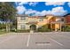 Beautiful multi-colored townhouses with covered front entryways and well manicured shrubs, including reserved parking at 8949 Candy Palm Rd, Kissimmee, FL 34747