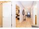 Inviting hallway leading to a bright living room and dining area with neutral tile floors at 8949 Candy Palm Rd, Kissimmee, FL 34747