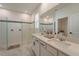 Luxurious bathroom with double vanity, frameless shower, and marble tile flooring creating an open, airy feel at 899 Asterfield Ln, Deland, FL 32720