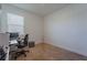 Neat bedroom featuring a desk, chair, computer setup, and a window providing natural light, perfect for work or study at 899 Asterfield Ln, Deland, FL 32720