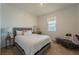 Cozy bedroom showcases a comfortable bed, side table with lamp, accent chair, and a window providing natural light at 899 Asterfield Ln, Deland, FL 32720