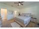 Bright bedroom boasts a ceiling fan, plush rug, and a comfortable bed with matching nightstands and decor at 899 Asterfield Ln, Deland, FL 32720