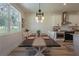 Bright dining room featuring a modern light fixture and a large window, creating an inviting space at 899 Asterfield Ln, Deland, FL 32720