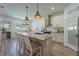 Modern kitchen with stainless steel appliances, a center island with bar seating, and white cabinetry at 899 Asterfield Ln, Deland, FL 32720