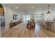 Open-concept living room featuring hardwood floors, a ceiling fan, and large windows for natural light at 899 Asterfield Ln, Deland, FL 32720