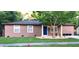 Charming single-story home with a well-manicured front lawn and a welcoming blue front door at 911 Kerry Blvd, Winter Haven, FL 33880