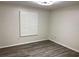 This bedroom features light hardwood flooring, neutral walls, a ceiling fan and window with shutters at 9319 Se 173Rd Hyacinth St, The Villages, FL 32162