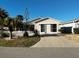 Charming single-story home featuring well-maintained landscaping, a paved driveway, and a screened garage at 9319 Se 173Rd Hyacinth St, The Villages, FL 32162