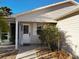 Inviting front porch featuring an open door, small garden, and a gravel walkway at 9319 Se 173Rd Hyacinth St, The Villages, FL 32162