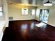 Living room featuring hardwood floors, a sliding glass door to the outdoors, and bright natural light at 9319 Se 173Rd Hyacinth St, The Villages, FL 32162