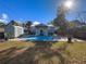 Backyard featuring a blue patio, a shed, and a wooden fence at 1418 Florida Ave, St Cloud, FL 34769