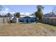 Backyard featuring a blue patio, a shed, and a wooden fence at 1418 Florida Ave, St Cloud, FL 34769