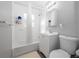 Bright, all-white bathroom with tub-shower combination, vanity, and toilet, offering a clean and functional space at 1418 Florida Ave, St Cloud, FL 34769