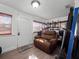 Cozy entryway with a recliner, a decorative door, and natural light from the window at 1418 Florida Ave, St Cloud, FL 34769