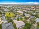 Sprawling community aerial shot showing well maintained landscaping, tree lined streets and community green spaces at 100 Ventana Dr, Kissimmee, FL 34759