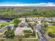 An aerial view of homes bordering a natural preserve and a pond in a well-maintained community at 100 Ventana Dr, Kissimmee, FL 34759