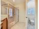 Bathroom featuring a spacious shower with glass door, toilet room, and tile flooring at 100 Ventana Dr, Kissimmee, FL 34759