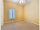 Cozy bedroom with a large window and soft carpet at 100 Ventana Dr, Kissimmee, FL 34759