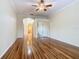 Spacious bedroom featuring hardwood flooring, a ceiling fan, and closet with mirrored doors at 100 Ventana Dr, Kissimmee, FL 34759