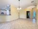The dining room showcases an open layout with views of the modern kitchen and an ornate front door at 100 Ventana Dr, Kissimmee, FL 34759