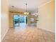 A chandelier hangs over the spacious dining room with views to the screened-in outdoor space at 100 Ventana Dr, Kissimmee, FL 34759