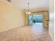 A chandelier hangs over the spacious dining room with access to the screened-in outdoor space at 100 Ventana Dr, Kissimmee, FL 34759