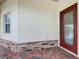 Stylish front entrance with a decorative glass door and brick accents adding curb appeal at 100 Ventana Dr, Kissimmee, FL 34759