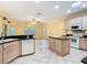 This sunny kitchen showcases an island, ample counter space, and natural light from the skylight at 100 Ventana Dr, Kissimmee, FL 34759