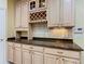 This kitchen features ample countertop space, custom wine storage, and light-colored cabinets at 100 Ventana Dr, Kissimmee, FL 34759