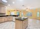 This kitchen offers an island with sink, stainless steel dishwasher, and ample light from many windows at 100 Ventana Dr, Kissimmee, FL 34759