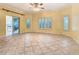 Spacious living area featuring tiled floors, neutral walls, and plantation shutters at 100 Ventana Dr, Kissimmee, FL 34759