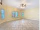 Bright and airy living room with neutral walls, tiled floor, and plantation shutters at 100 Ventana Dr, Kissimmee, FL 34759