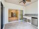 This outdoor kitchen features a stainless steel mini fridge, grill, sink, and ceramic tile backsplash at 100 Ventana Dr, Kissimmee, FL 34759