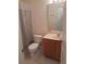 Standard bathroom with neutral tiles and a shower featuring patterned curtain at 1111 Oscar Sq, Celebration, FL 34747