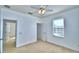 Carpeted bedroom featuring a ceiling fan and a window for natural light at 1111 Oscar Sq, Celebration, FL 34747