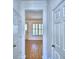 Inviting hallway with wood flooring, white walls, and doors leading to various rooms at 1111 Oscar Sq, Celebration, FL 34747
