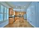Bright kitchen features wood cabinets, granite countertops, a center island, and stainless steel appliances at 1111 Oscar Sq, Celebration, FL 34747