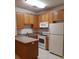 Efficient kitchen featuring wooden cabinetry, a breakfast bar, and practical appliances at 1111 Oscar Sq, Celebration, FL 34747