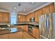 Well-equipped kitchen features wooden cabinets, granite countertops, stainless steel appliances and mosaic backsplash at 1111 Oscar Sq, Celebration, FL 34747