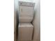 This laundry area features a stacked washer and dryer for space saving at 1111 Oscar Sq, Celebration, FL 34747