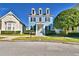Charming blue two-story home with black shutters and a well-manicured front yard at 1111 Oscar Sq, Celebration, FL 34747