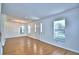 Spacious living area featuring wood floors, large windows, and modern lighting at 1111 Oscar Sq, Celebration, FL 34747