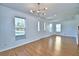 Bright living room with wood flooring and large windows showcasing a welcoming space at 1111 Oscar Sq, Celebration, FL 34747