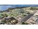 Expansive aerial view of a residential community nestled by the water, showcasing lush greenery and well-planned streets at 1116 Caloosa Ridge Way, Babson Park, FL 33827