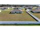 Expansive backyard enclosed by a pristine white fence offers ample space for recreation and outdoor activities at 1116 Caloosa Ridge Way, Babson Park, FL 33827