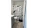 Cozy bathroom featuring a toilet, vanity with modern gray cabinets, and a shower with a themed shower curtain at 1116 Caloosa Ridge Way, Babson Park, FL 33827