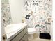 Small bathroom with a modern vanity, toilet, and themed shower curtain at 1116 Caloosa Ridge Way, Babson Park, FL 33827